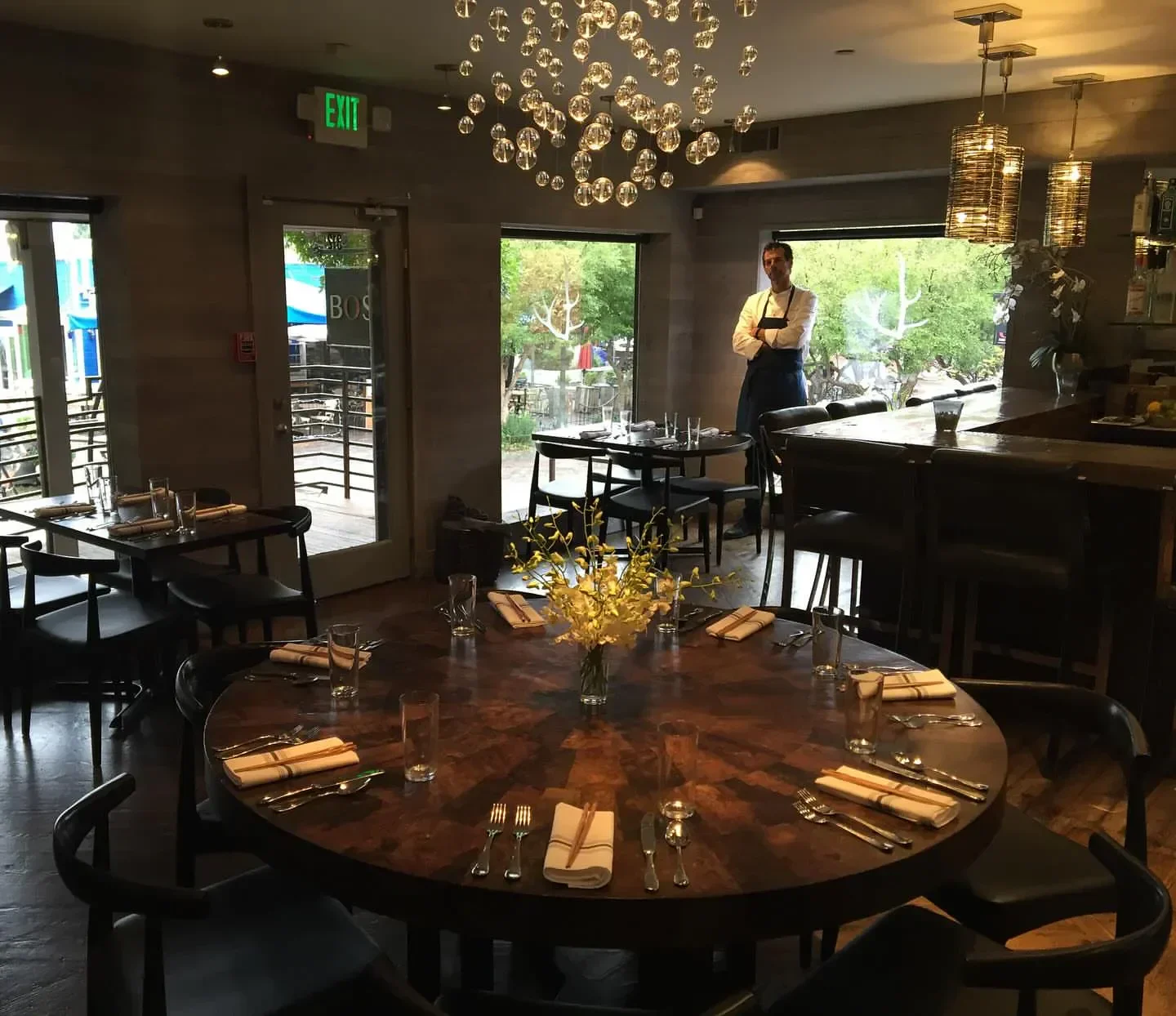 Interior of Bosq restaurant in Aspen. A well-set table awaits diners.