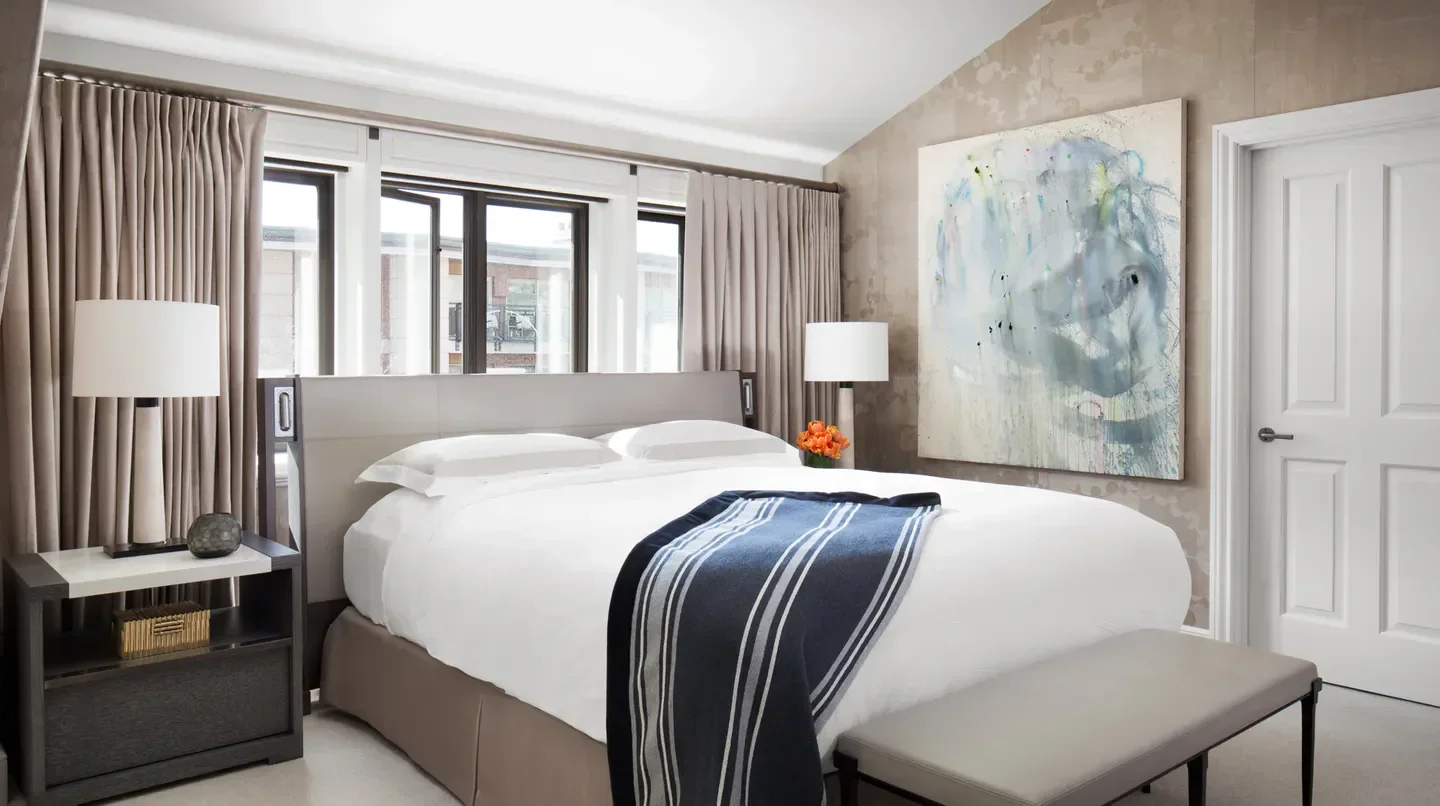 Elegant bedroom at The Little Nell in Aspen with stylish decor and comfortable bedding.