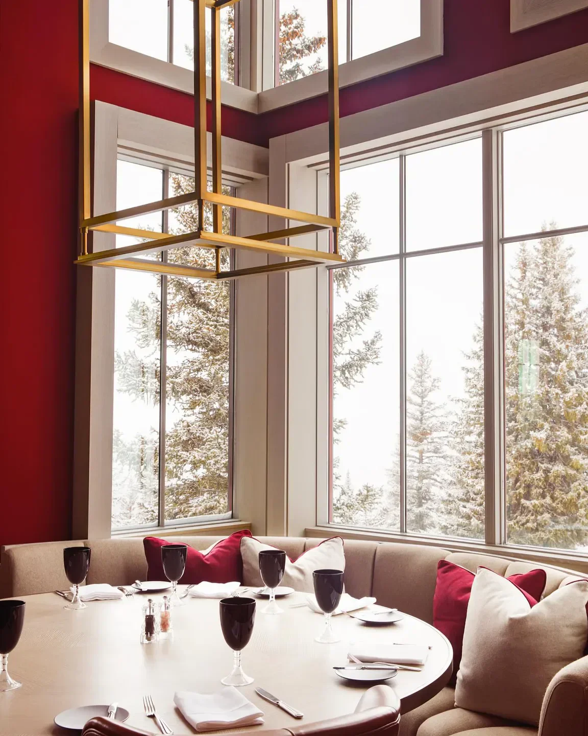 Cozy dining area at The Wine Bar in Aspen, with winter views and elegant table setting.
